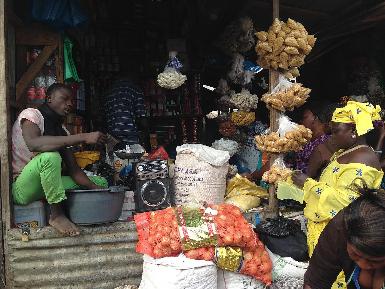 Customers and goods inside a small shop in Serrekunda Market